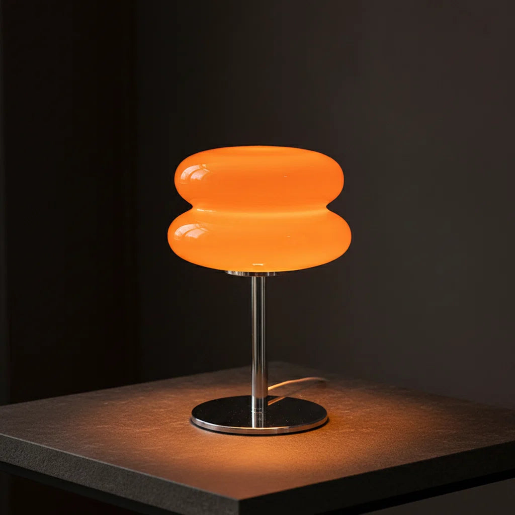 Orange table lamp on a wooden table with books and a mug, branded 'JIADA HOME LIGHTING'.