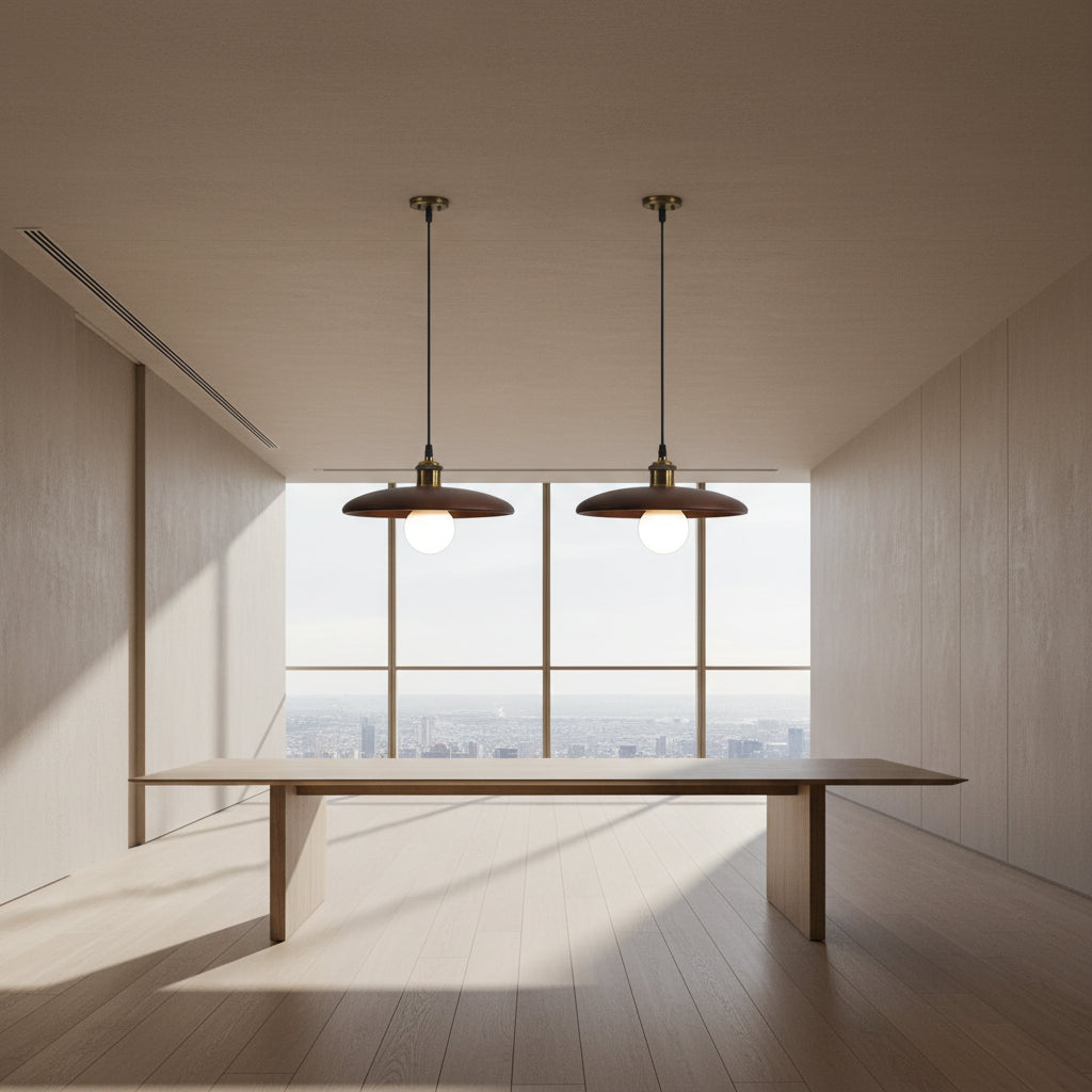 Two pendant lights hanging above a table with a neutral background