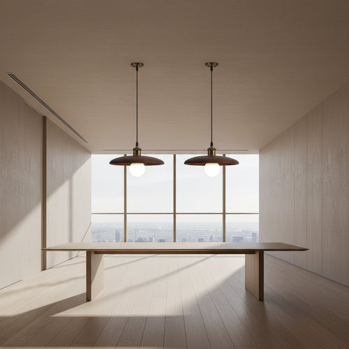 Two pendant lights hanging above a table with a neutral background