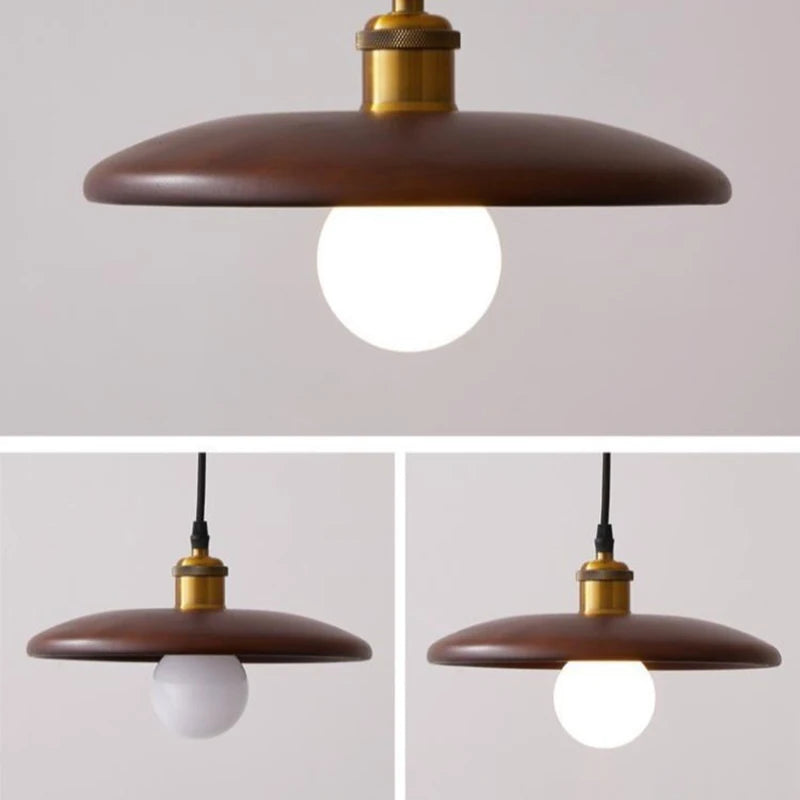 Pendant light fixture with brown shade and gold accents on a plain background