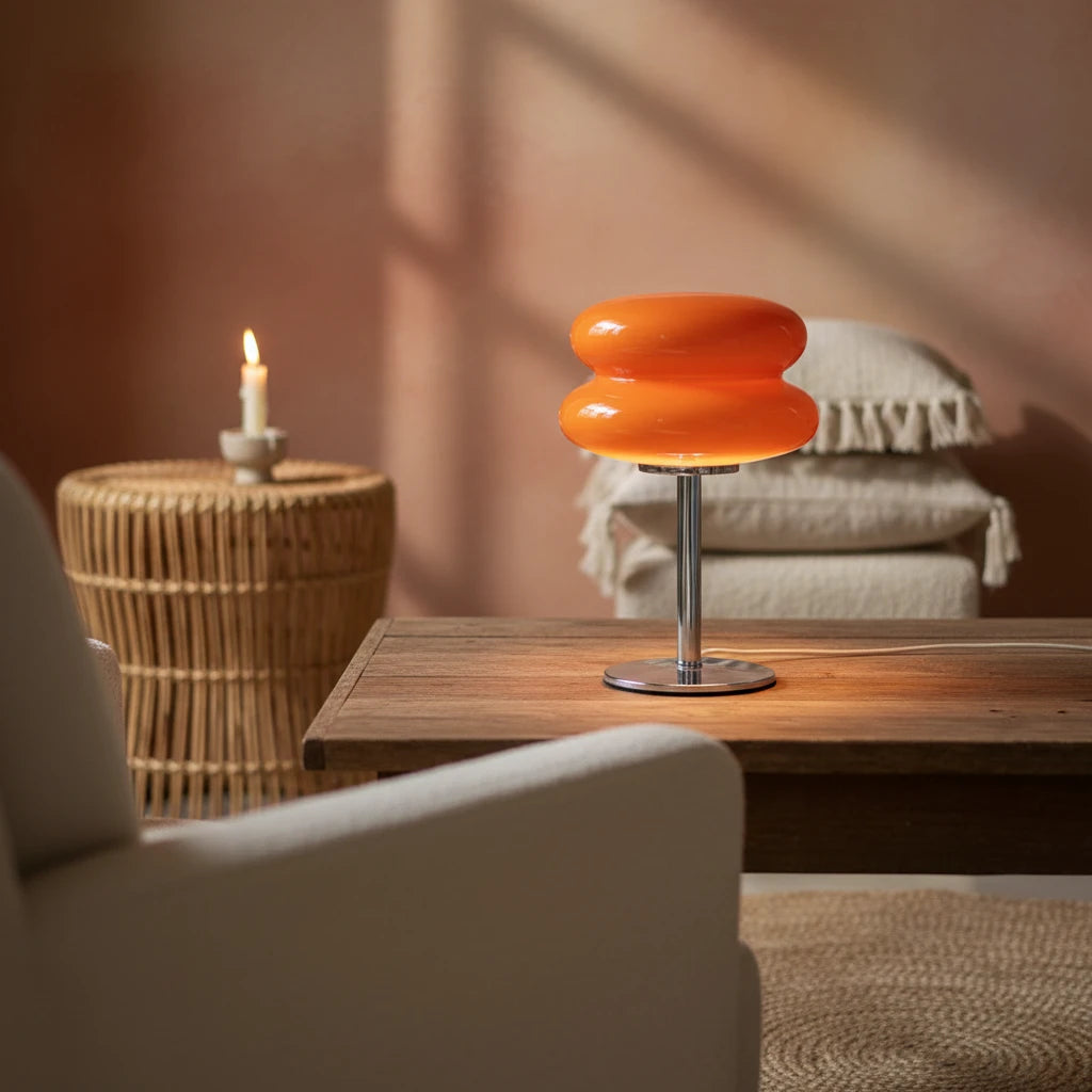 Orange lamp on a wooden table with books and a plant in the background, featuring 'JIADA HOME LIGHTING' text.