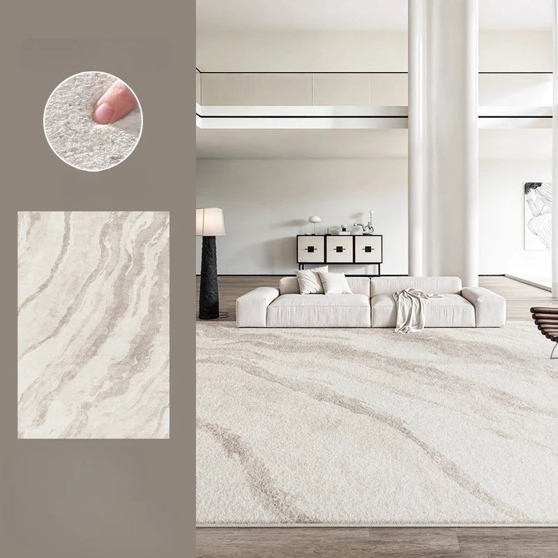 A large light beige area rug with soft wavy marbled stripes is shown in a modern living room setting. The image includes a circular inset showing a close-up of the plush pile texture with a finger for scale, and a rectangular fabric swatch on the left.